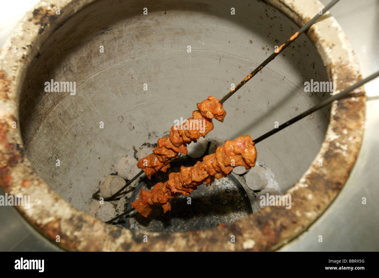 Lamb skewers in a tandoori oven.  Essence of India Restaurant Stock Photo