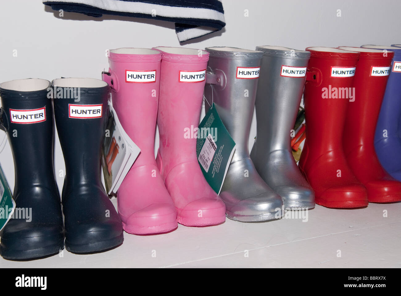 Childrens Hunter colourful coloured wellington wellie boots for sale inside a uk shop store Stock Photo