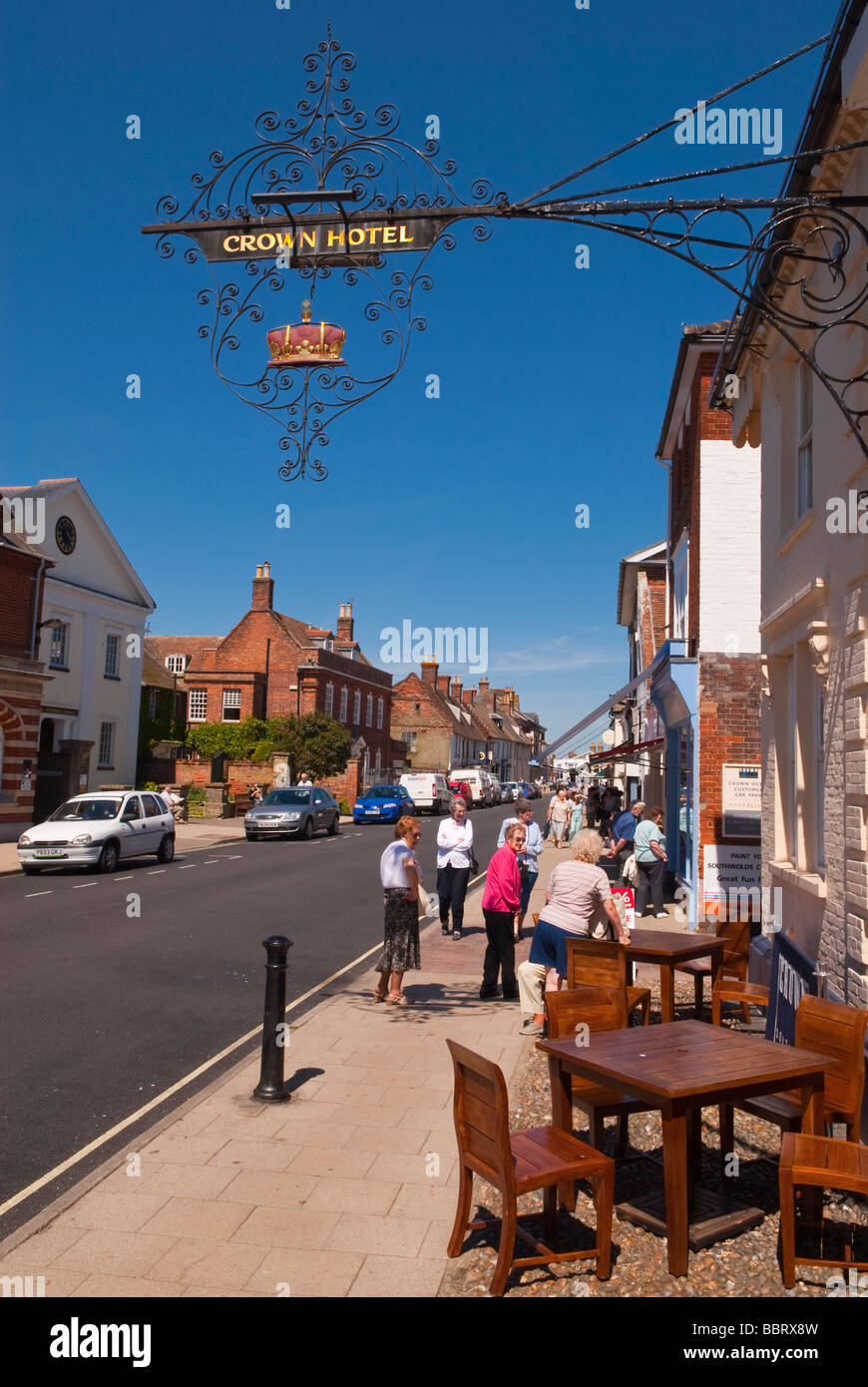A view looking up Southwold high street with people shopping and the crown hotel in the foreground in Suffolk Uk Stock Photo