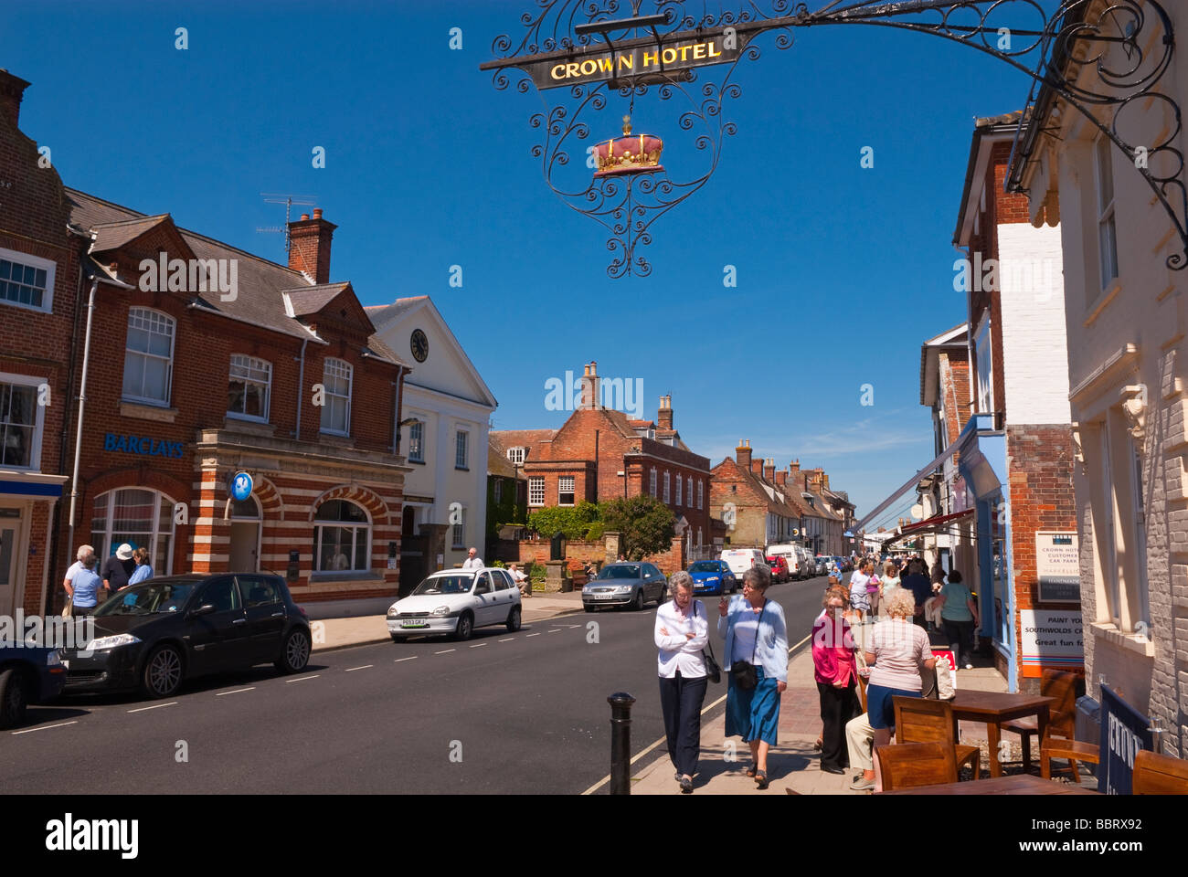 A view looking up Southwold high street with people shopping and the crown hotel in the foreground in Suffolk Uk Stock Photo