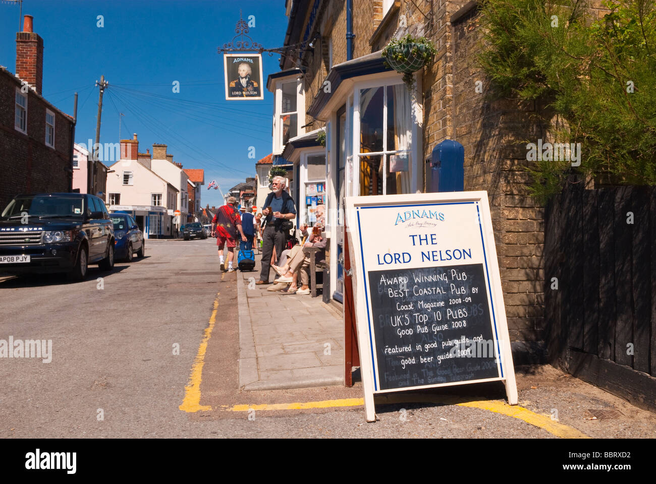 The Lord Nelson pub ( Adnams ) in Southwold Suffolk Uk with customers outside ( award winning best coastal pub ) in the summer Stock Photo