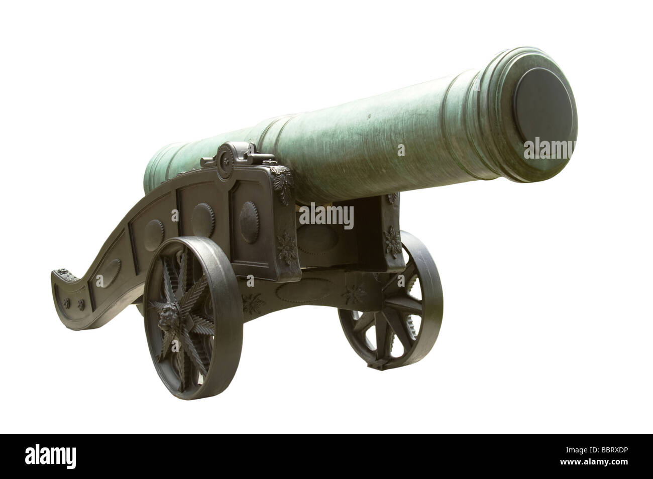 Historical weathered bronze cannon on dark cart Stock Photo