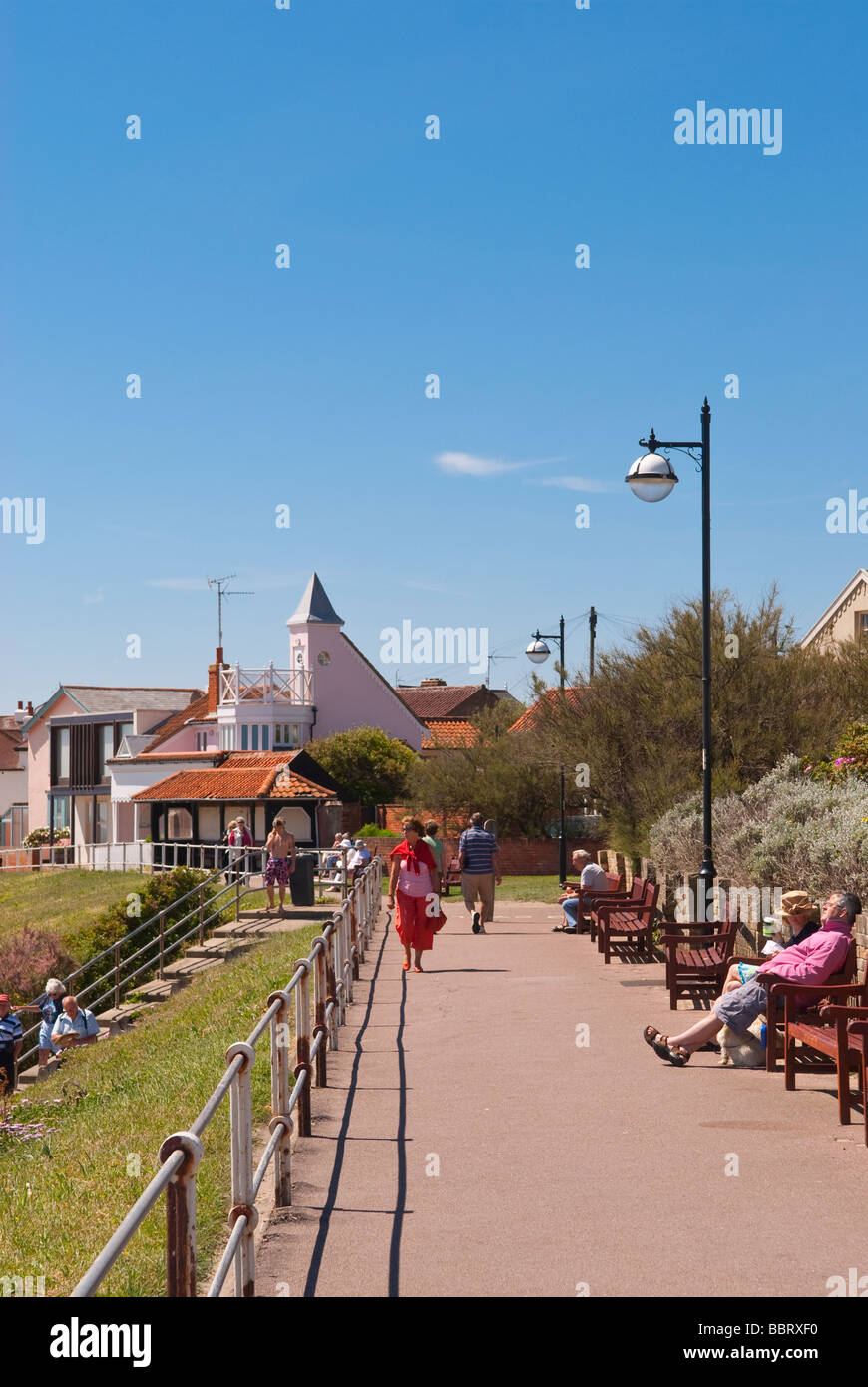 A view along the seafront promenade of Southwold Suffolk Uk with people enjoying the picturesque location in the summer Stock Photo