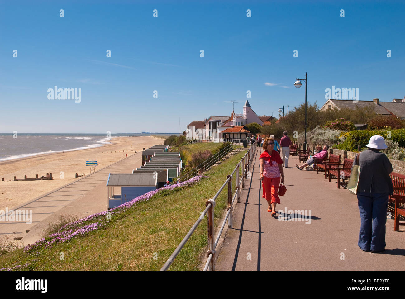 A view along the seafront promenade of Southwold Suffolk Uk with people enjoying the picturesque location in the summer Stock Photo