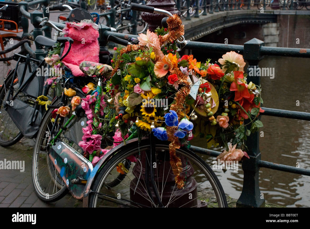 Bycicle at the canals decorated with flowers Amsterdam Netherlands Stock Photo