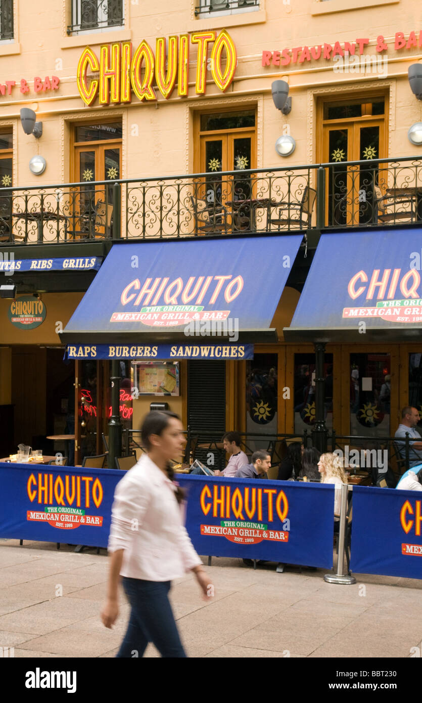 A girl walks past Chiquito restaurant, Leicester Square, London, UK Stock Photo