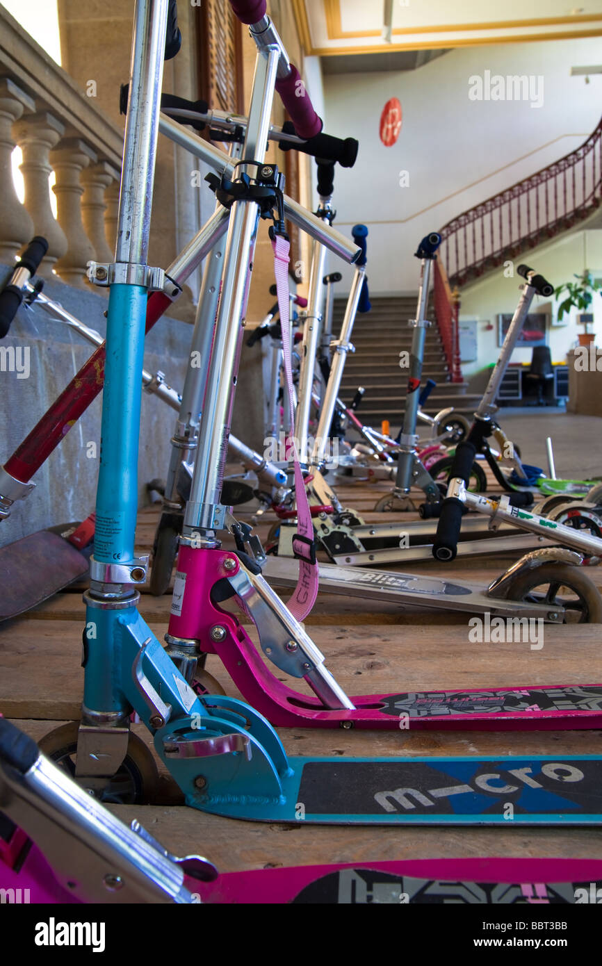 Children's scooters piled in a stack at school Stock Photo Alamy