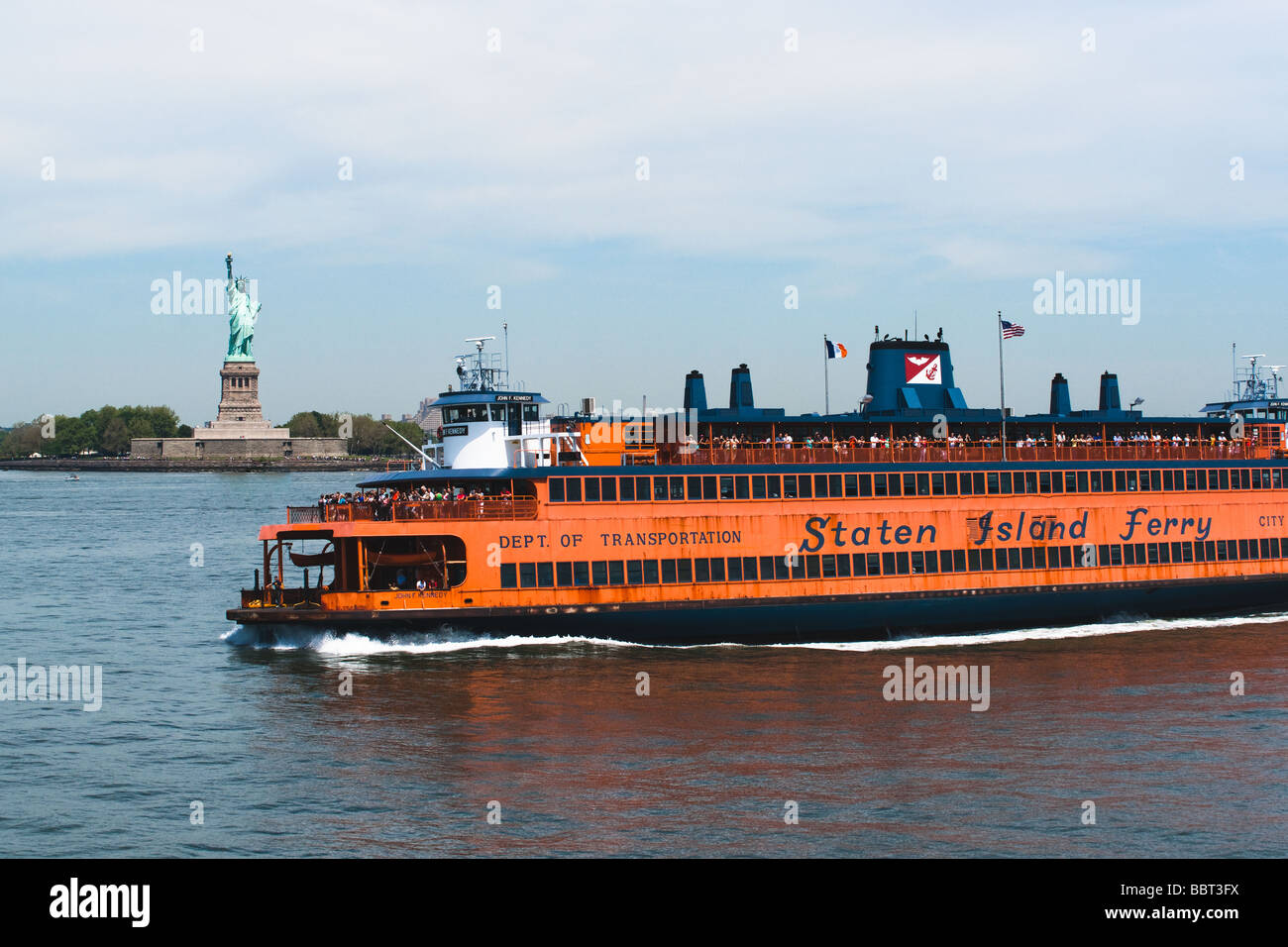 The Staten Island Ferry filled with tourists and passangers passing the