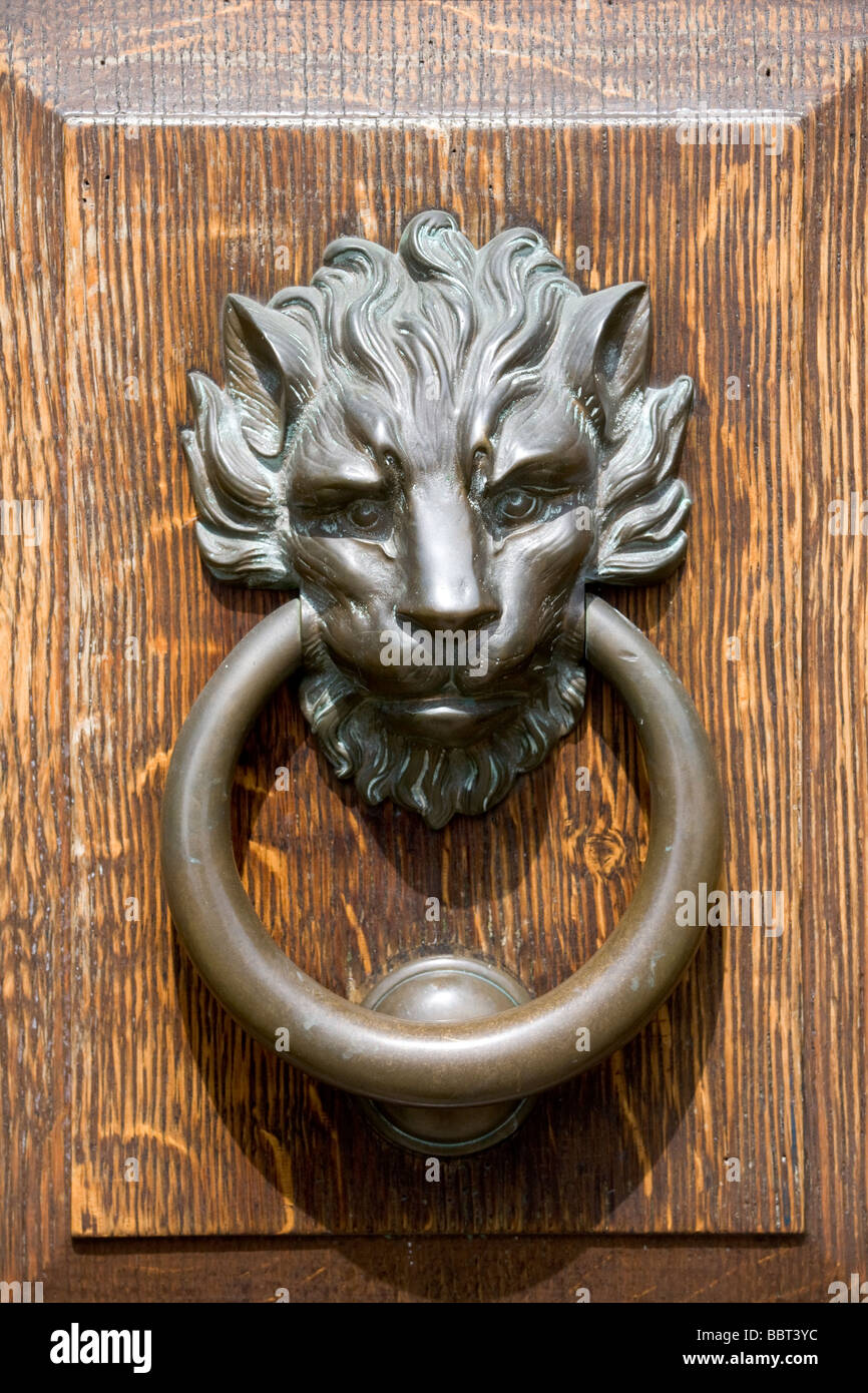 wooden door with lion head brass knocker Stock Photo