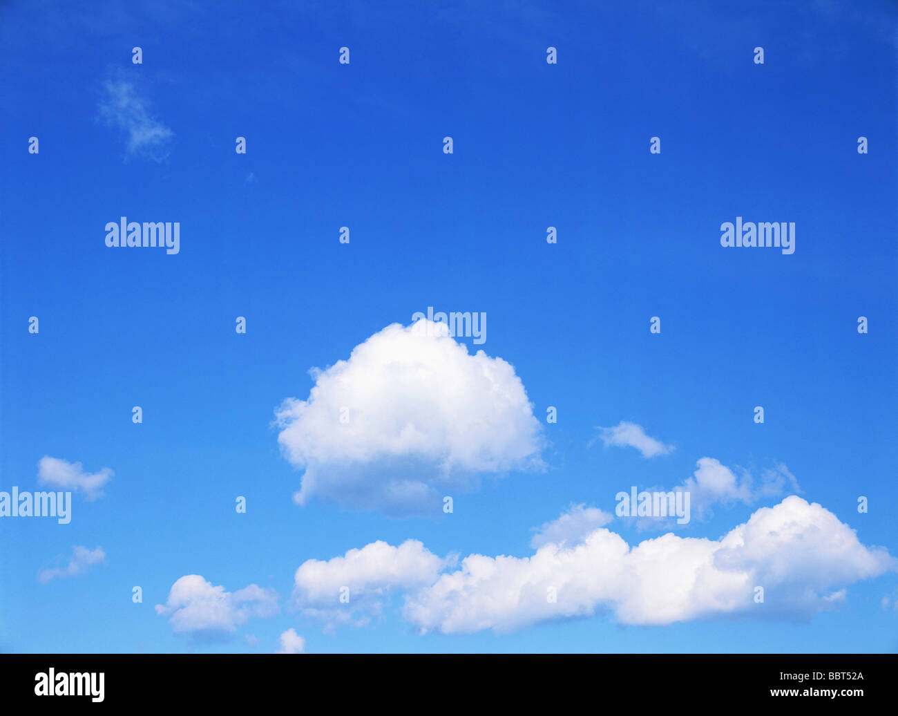 Blue sky with fluffy clouds Stock Photo - Alamy
