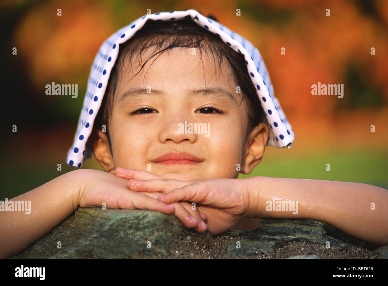 Smiling Japanese girl with towel on her head Stock Photo Alamy