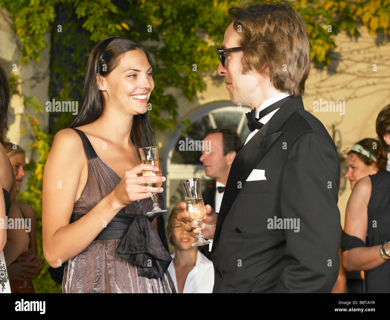 Couple drinking champagne at sunset Stock Photo
