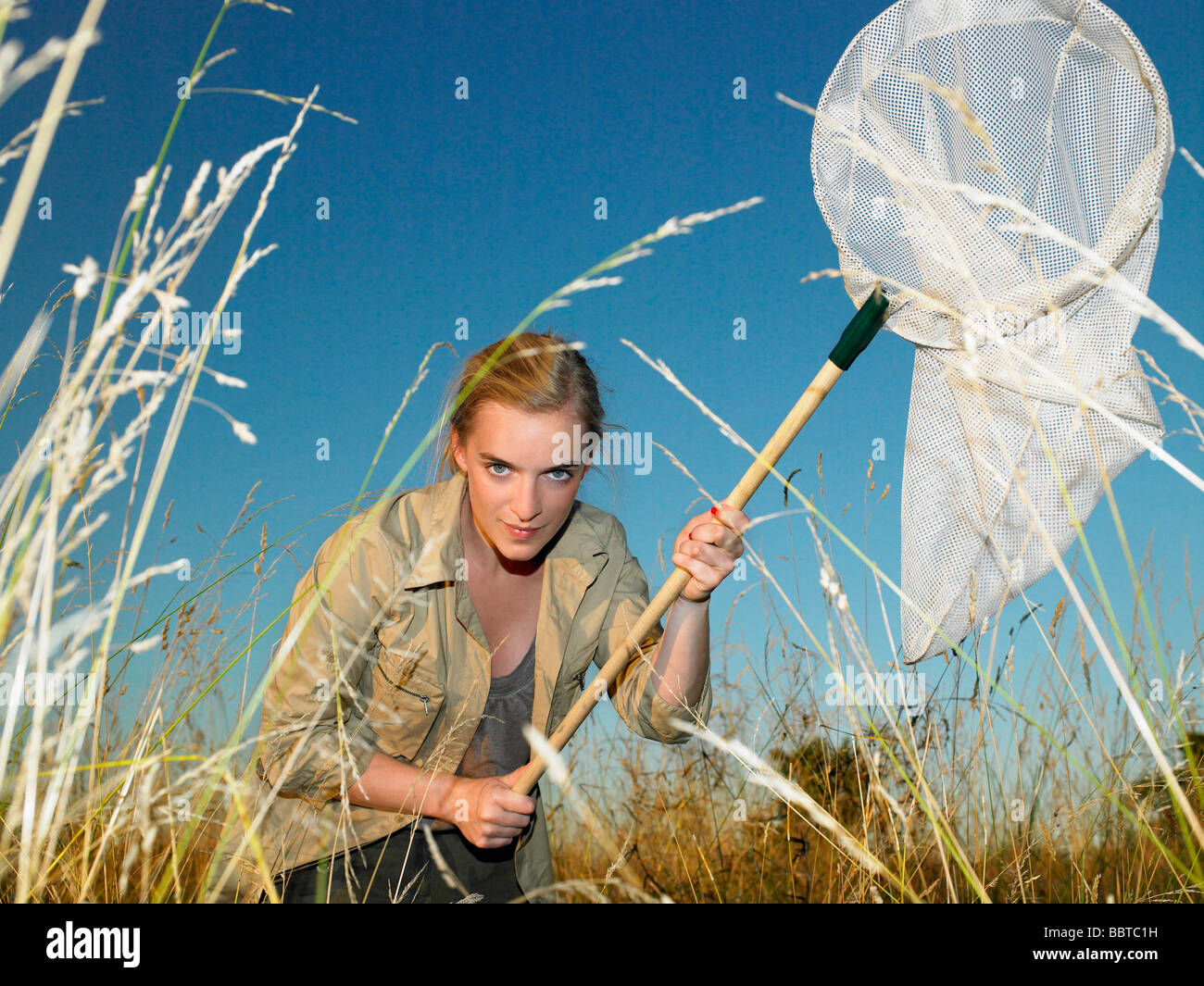 Woman with butterfly net Stock Photo - Alamy