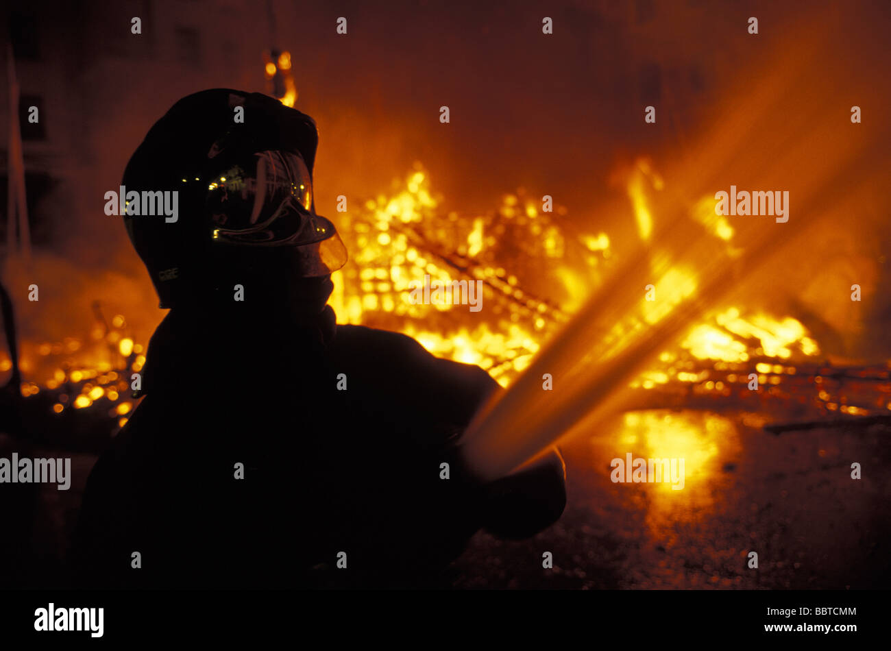 Valencia firemen controlling the fire at the burning of the ninos the Las Fallas festival Stock Photo