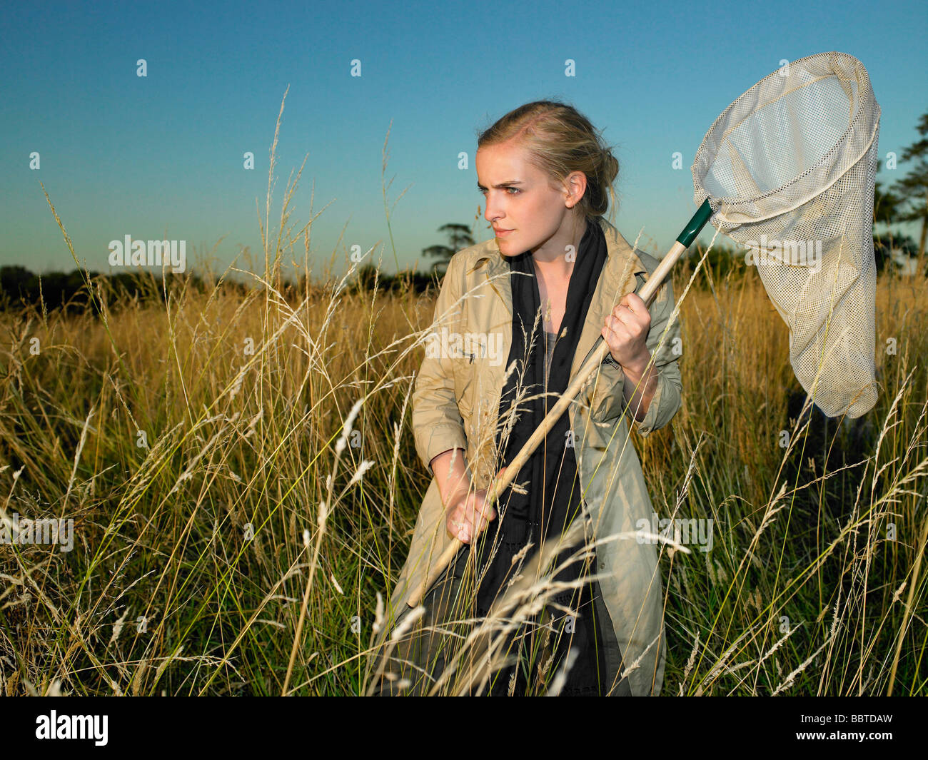 Woman with butterfly net Stock Photo