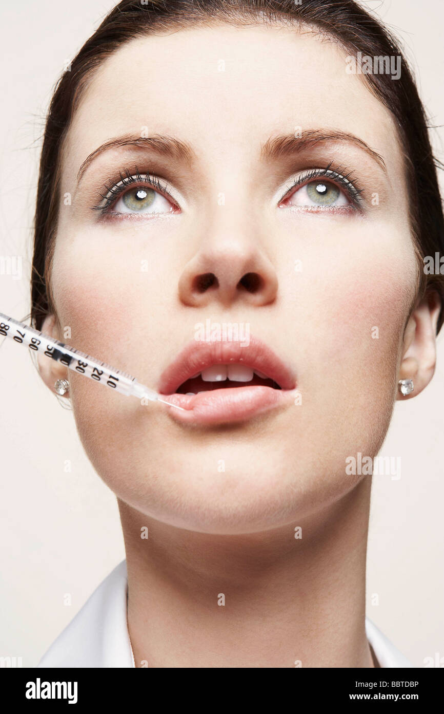 Woman with hypodermic syringe Stock Photo