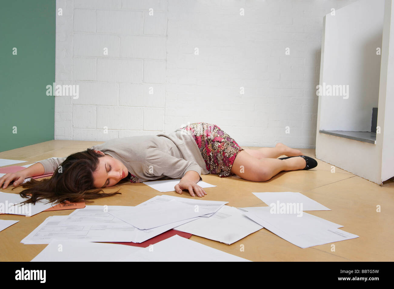 Female office worker lying on floor Stock Photo Alamy