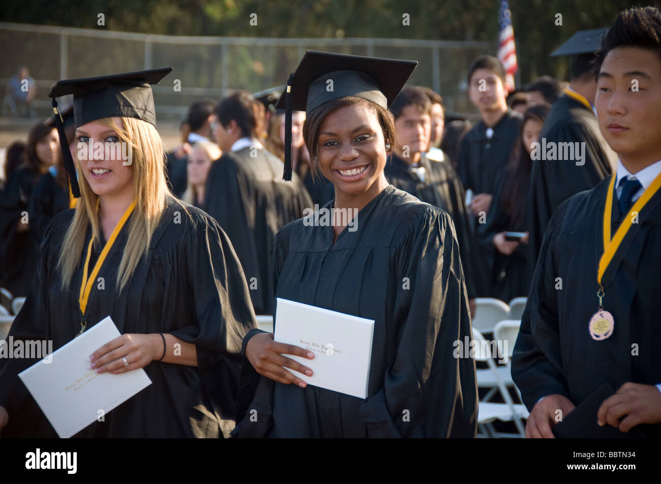 White African American Black Asian High School Graduation grad diploma teen teenager Stock Photo