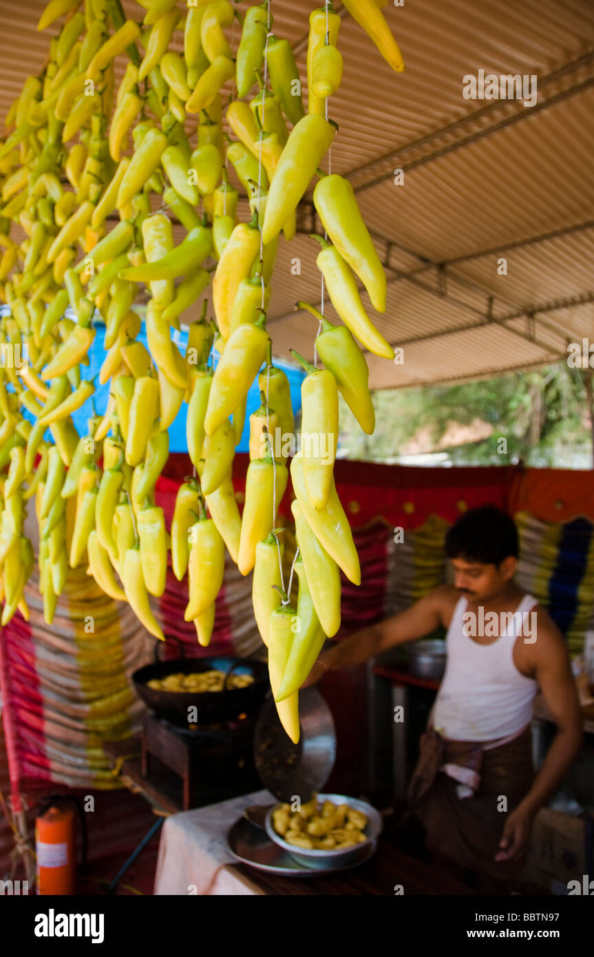 Indian street cook frying chilly pakodas in a tea shop Stock Photo