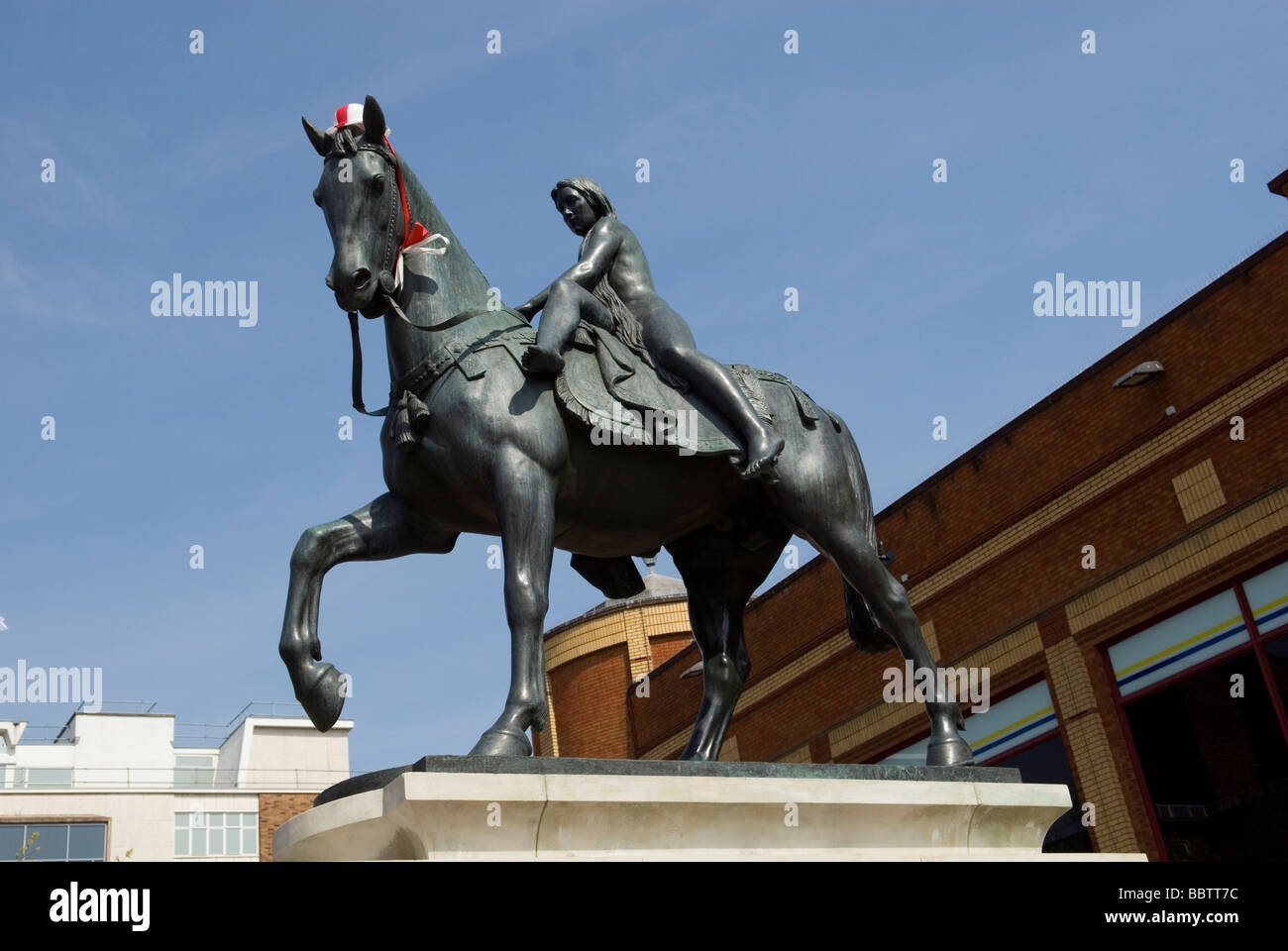 Statue of Lady Godiva wearing red and white hat Stock Photo