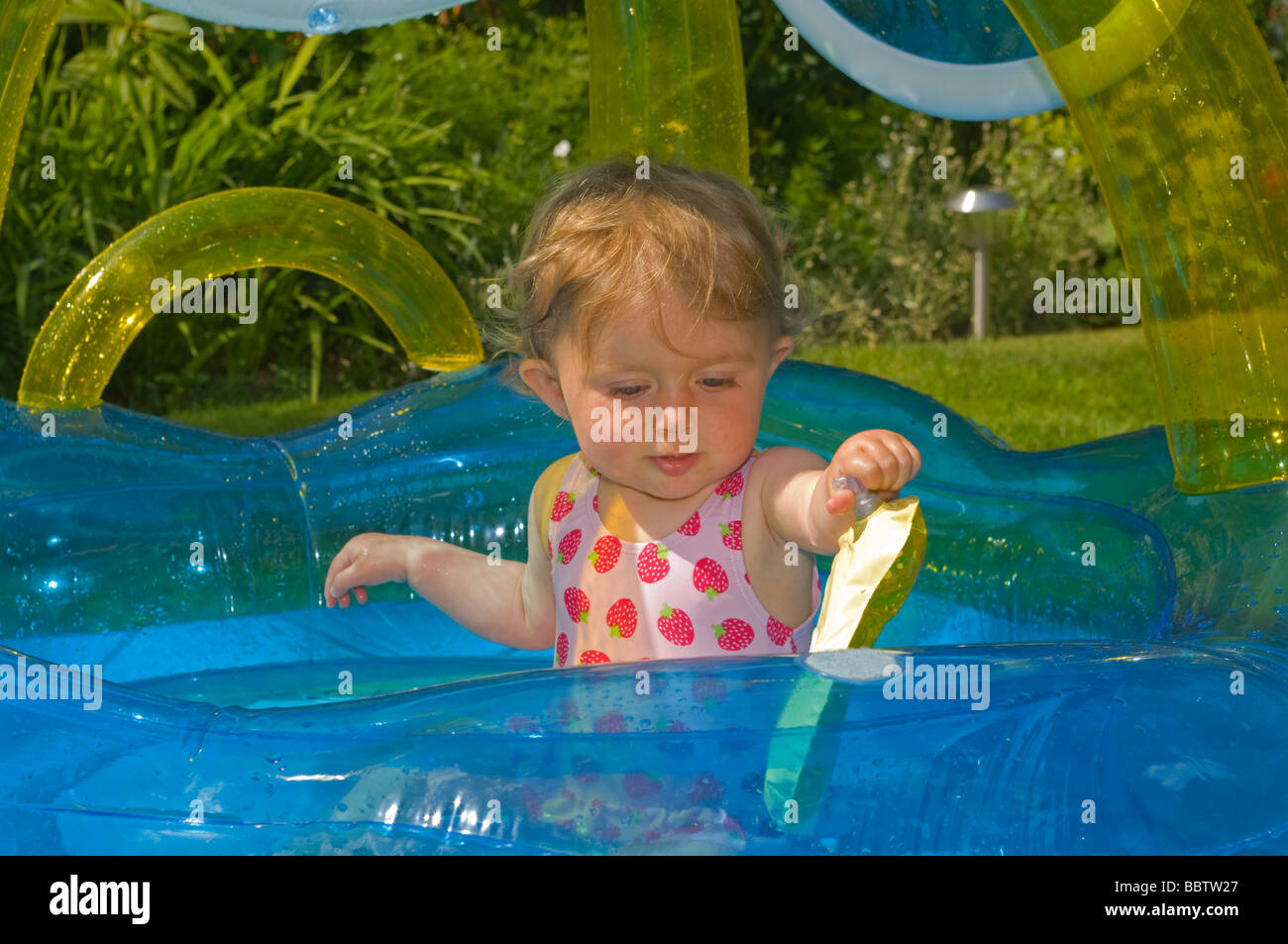 Baby Girl Playing In a Paddling Pool Stock Photo Alamy