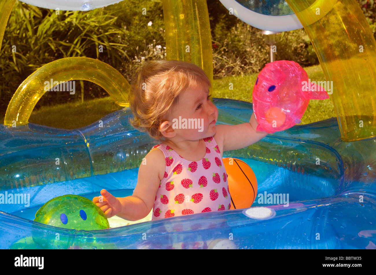 Baby Girl Playing In a Paddling Pool Stock Photo Alamy