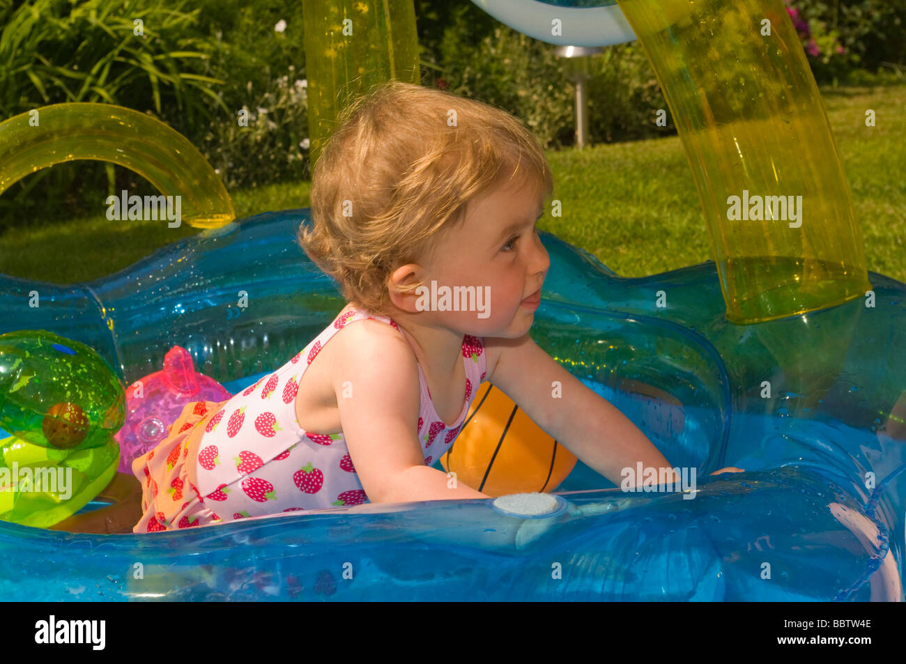 Baby Girl Playing In a Paddling Pool Stock Photo Alamy