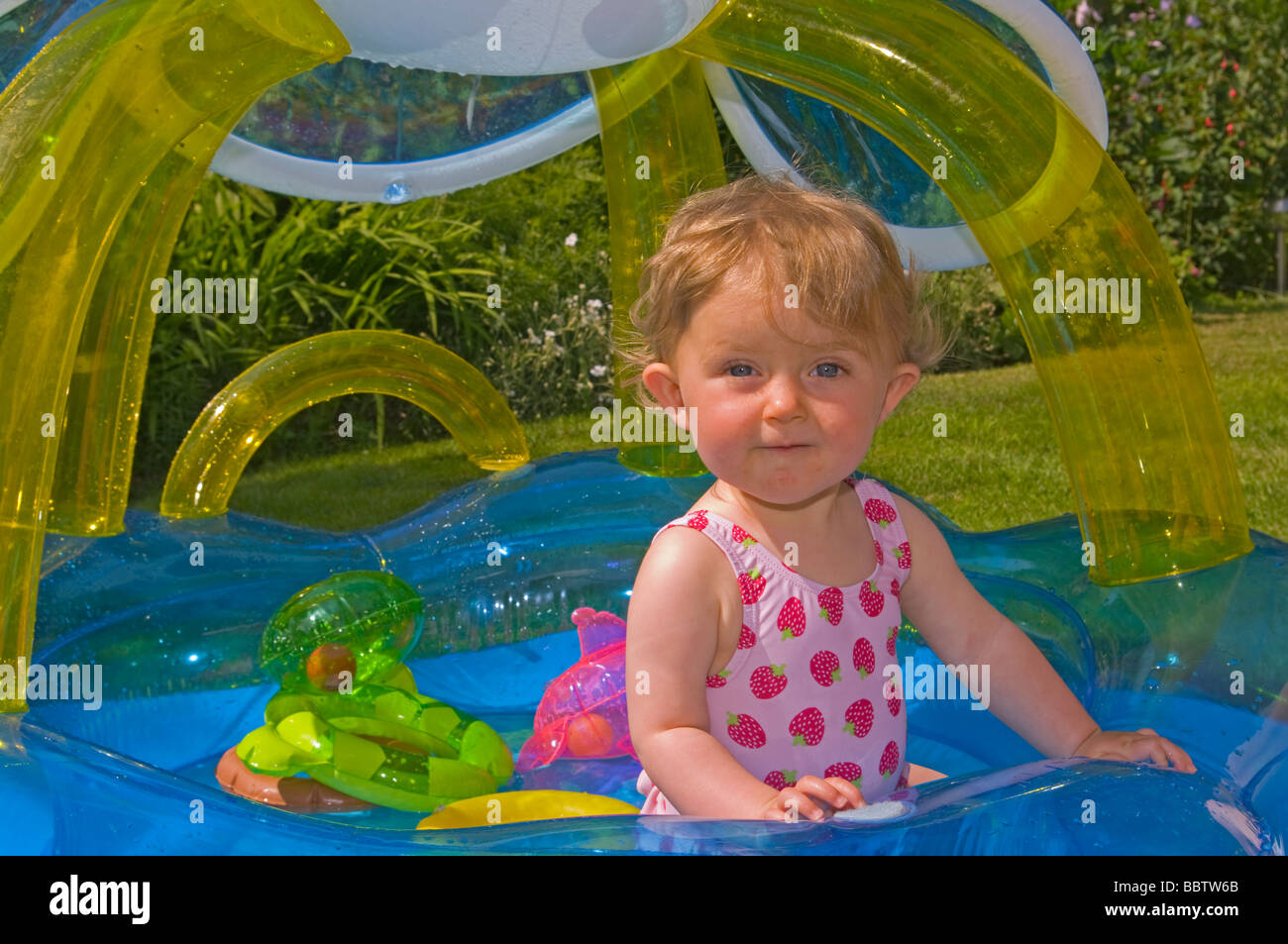 Baby Girl Playing In a Paddling Pool Stock Photo Alamy