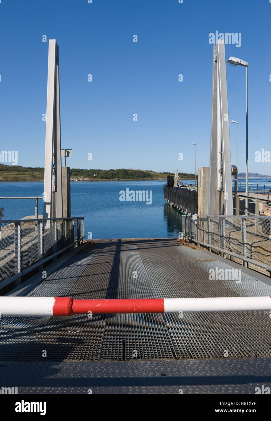 Metallic moorage with a barrier ashore arm of the sea Stock Photo