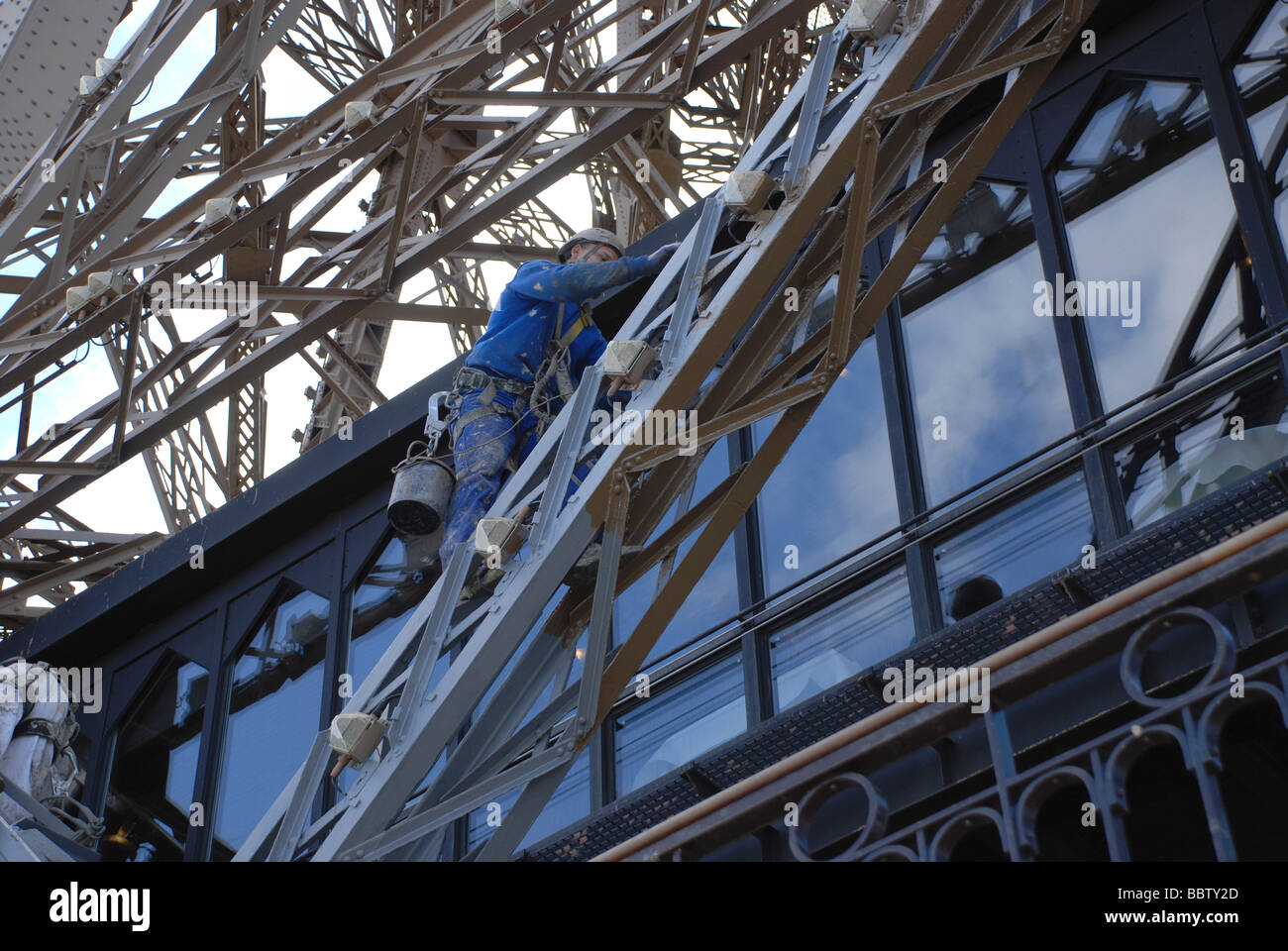 Paris, Workman painting Eiffel Tower Stock Photo