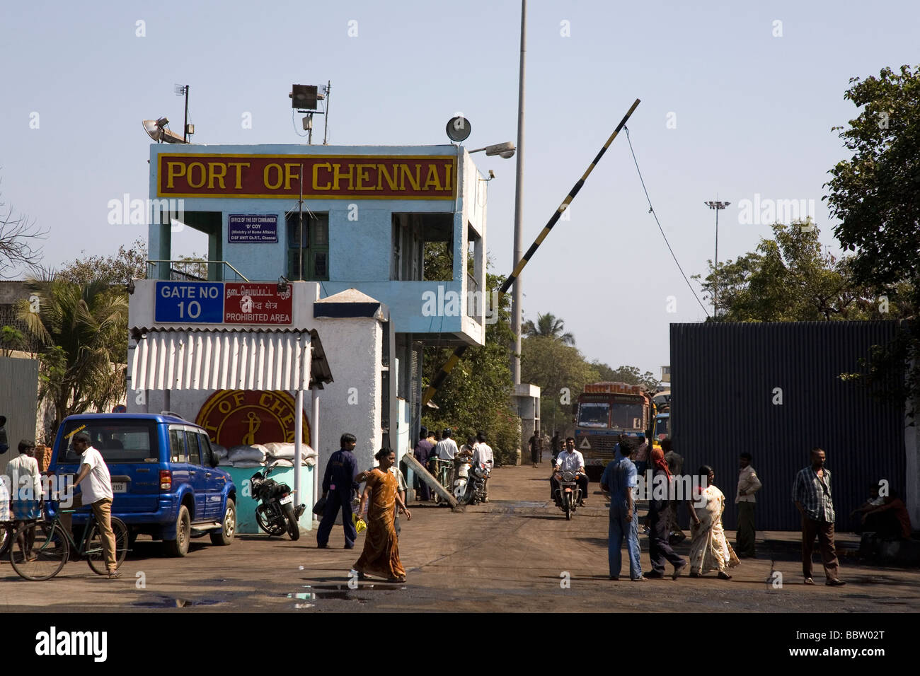 The gates of the Port of Chennai, India. People and traffic move about at the entrance to the port. Stock Photo