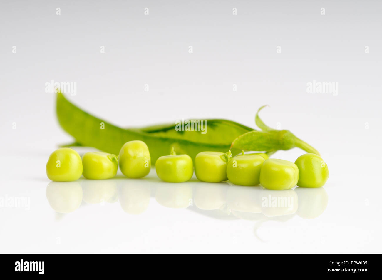 Fresh garden peas in a pod against a white background Stock Photo