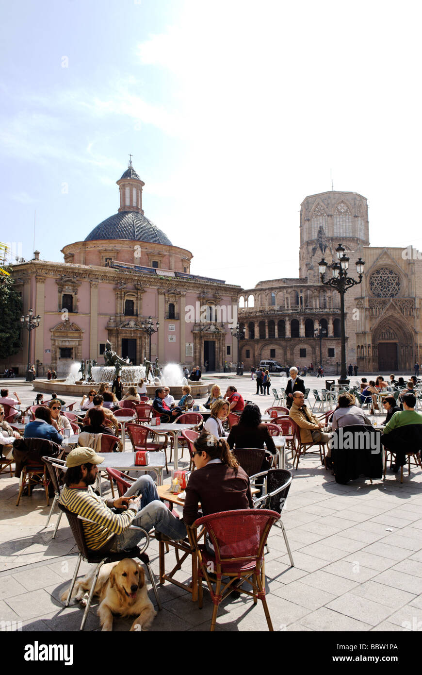 People sitting in cafe terrace in front of the cathedral on Plaza de la Virgen in central Valencia Spain Stock Photo