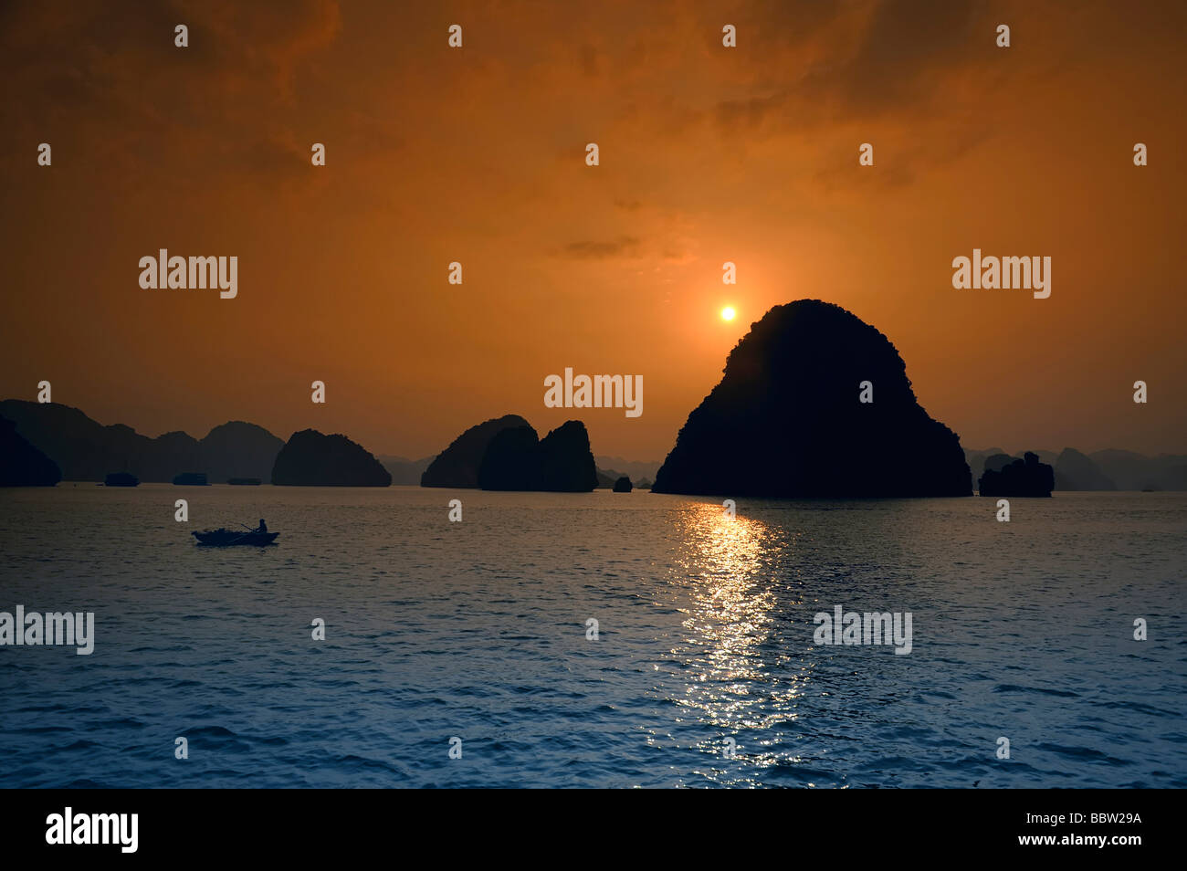 Fishing boat at sunset, Halong Bay, Hanoi, Southeast Asia Stock Photo