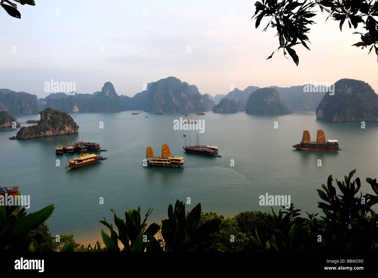 Ships in front of rock formations, Halong Bay, Hanoi, Southeast Asia Stock Photo