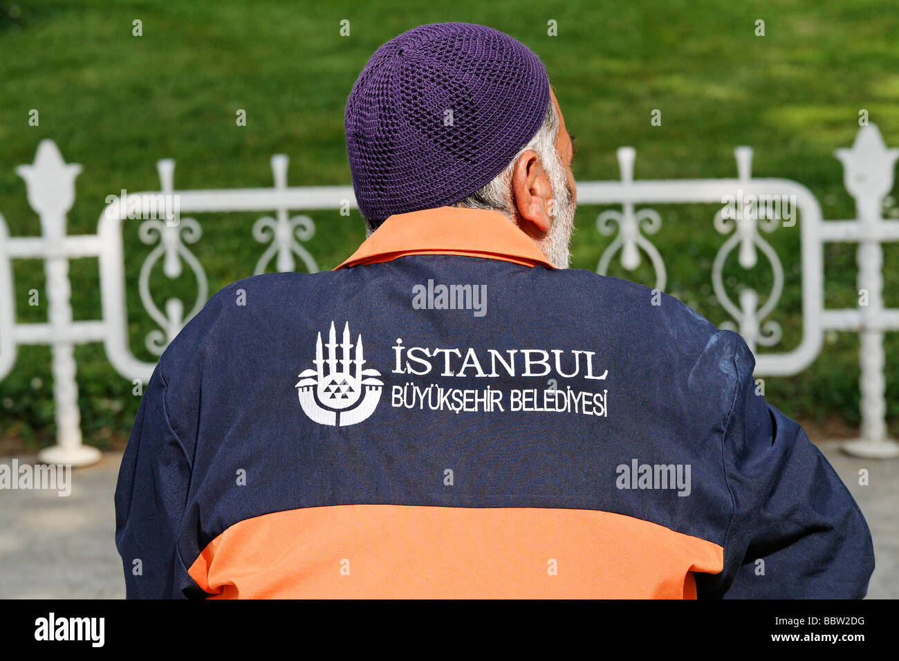 Staff of the Municipal Gardens, large logo on the dress, back view, Sultanahmet, Istanbul, Turkey Stock Photo