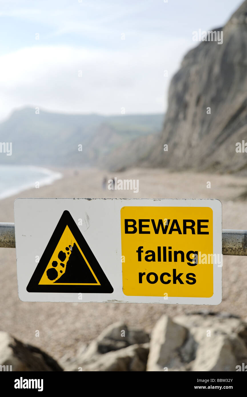 Sign warning of loose falling rocks from cliffs along the Dorset Jurassic coastline South West England UK Stock Photo