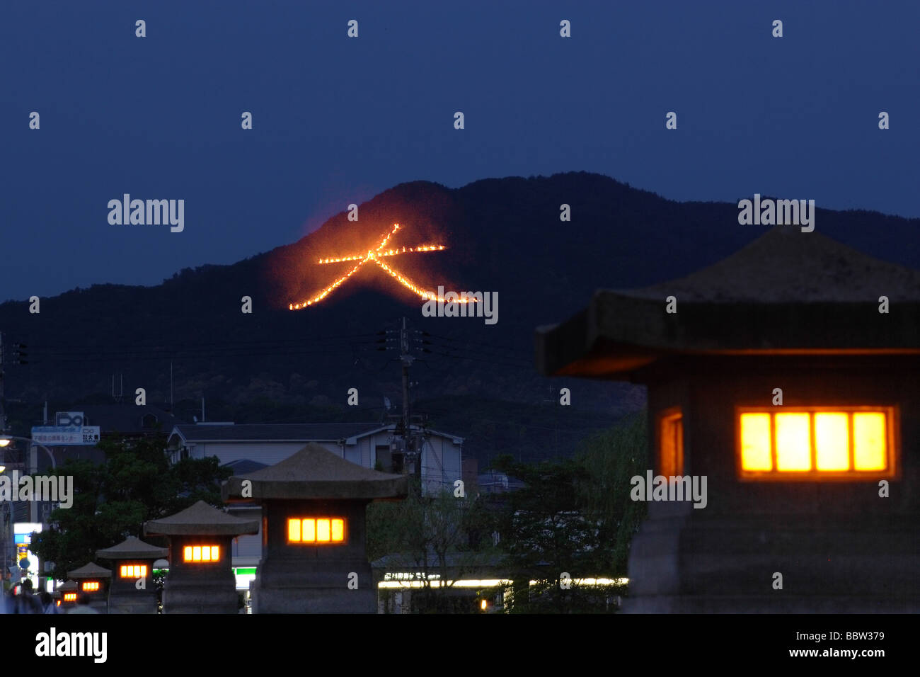 Japanese sign on hilltop with illuminated lights Stock Photo