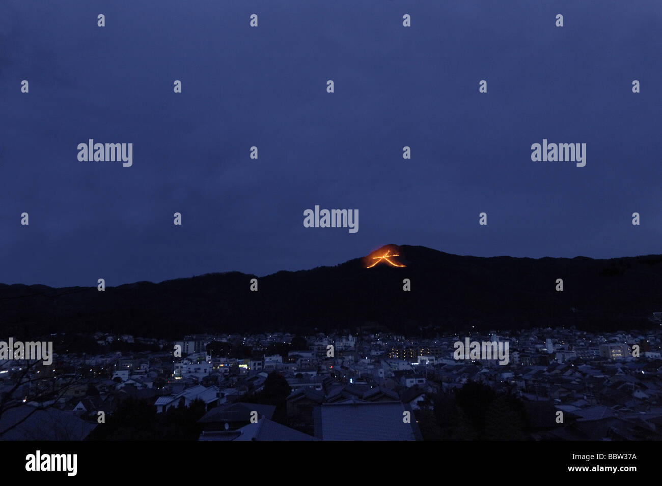 Japanese controlled fire sign illuminating a hilltop Stock Photo