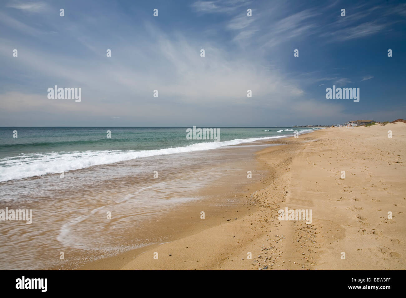Landscape beach photograph of a sandy beach with a big blue sky and ...