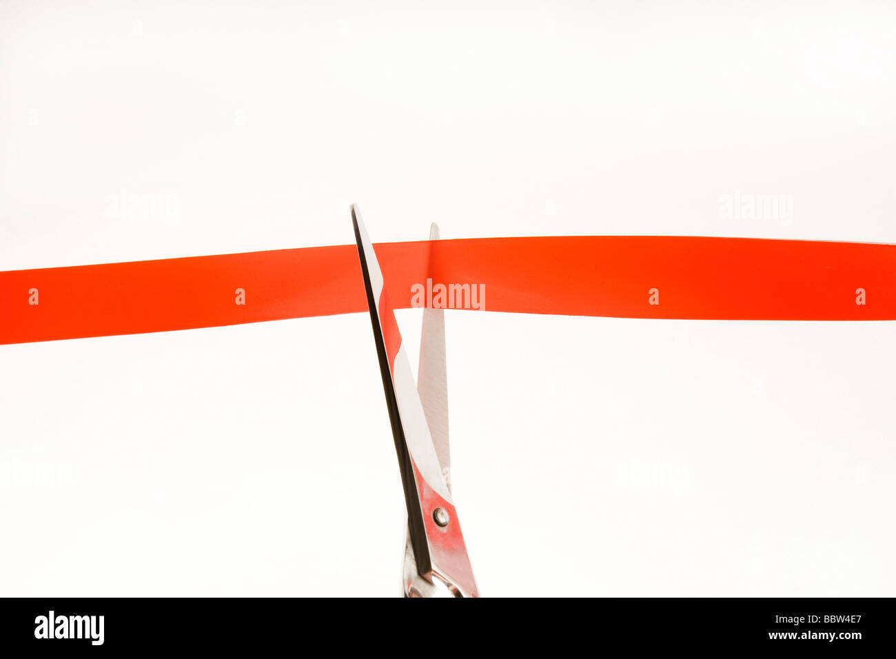 Scissors cutting red tape Stock Photo Alamy