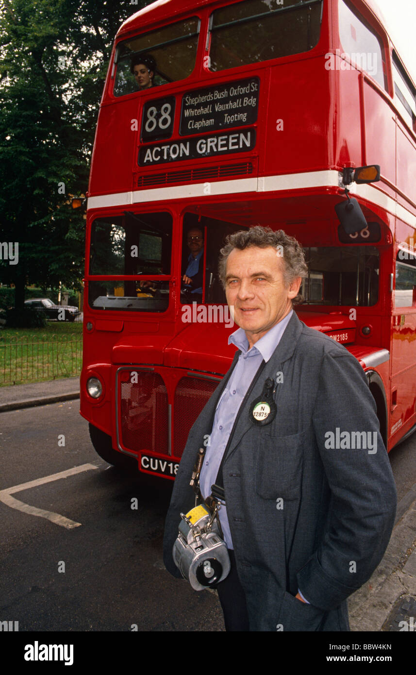 Number 88 red London routemaster bus and traditional conductor portrait Stock Photo