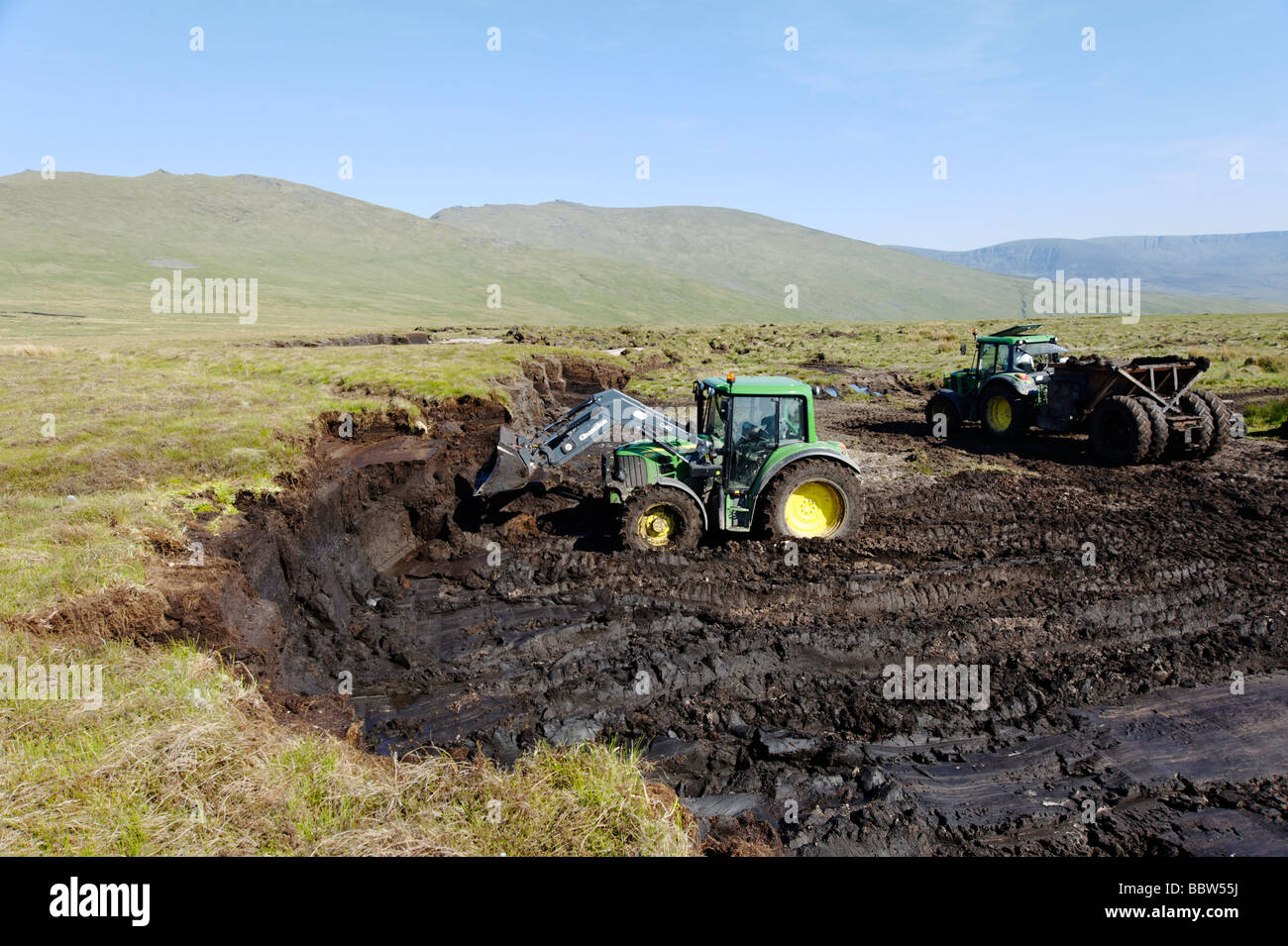 Large scale peat excavation with machinery from a bog in County Tipperary which can be used for garden centre fertiliser Ireland Stock Photo