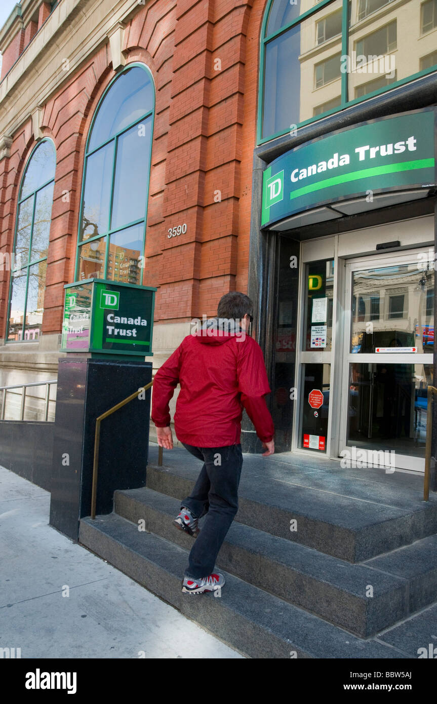 Man entering Canada Trust Bank on Boulevard Saint Laurent Montreal Stock Photo