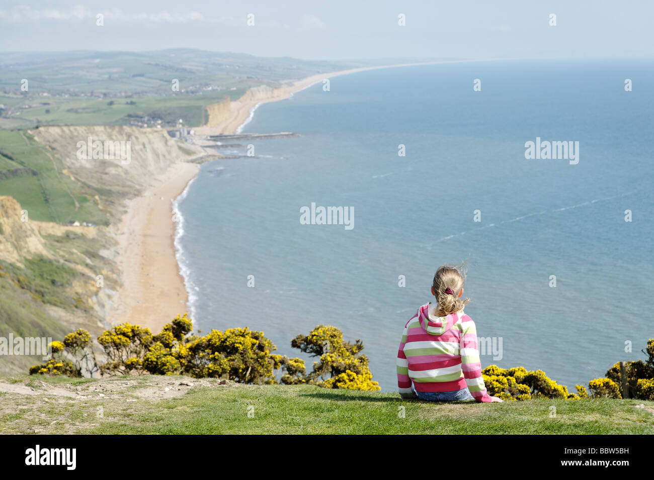 Young girl on coast path overlooking the Dorset Jurassic coastline South West England UK Stock Photo