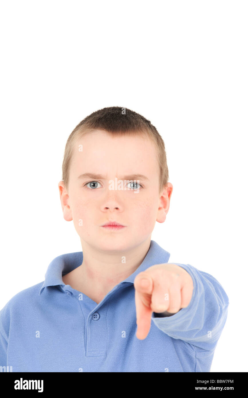 Portrait of young boy pointing finger, studio shot Stock Photo