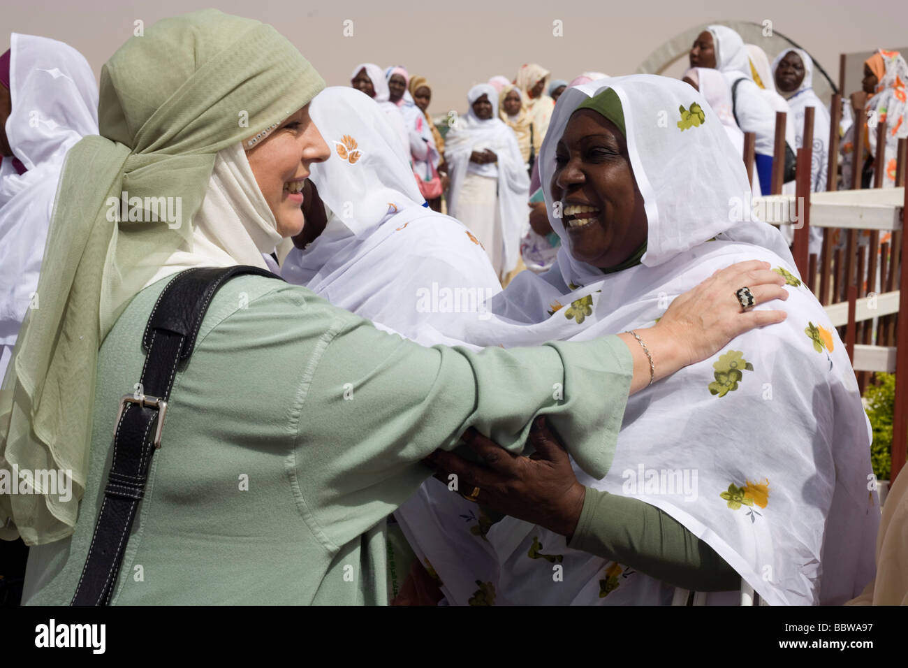 British Muslim activist, TV broadcaster and journalist, Yvonne Ridley is greeted by women at Al-Fashir airport Stock Photo