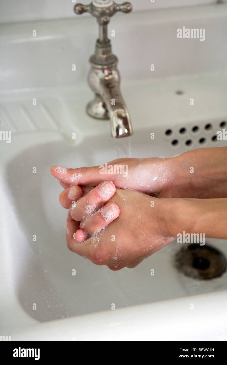woman washing hands in sink, close-up Stock Photo