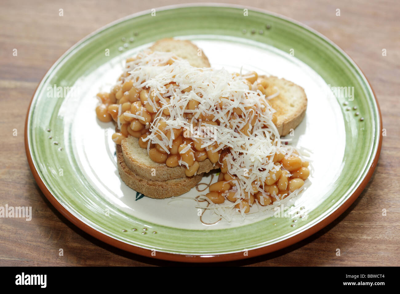 Baked Beans and Parmesan Cheese on Bruschetta Stock Photo