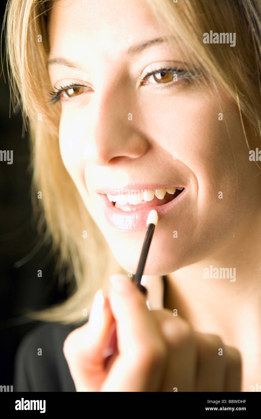 woman applying lipstick,  making up Stock Photo